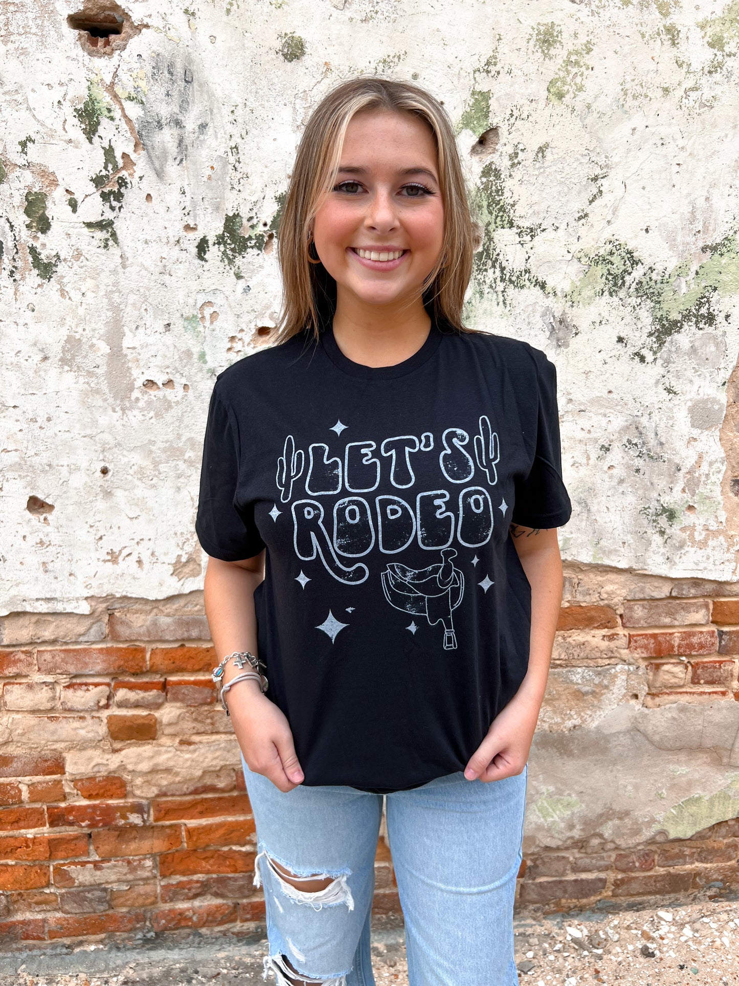 Let's Rodeo with stars and saddle - Black Tee-Top-the lattimore claim-09/12/23-The Twisted Chandelier